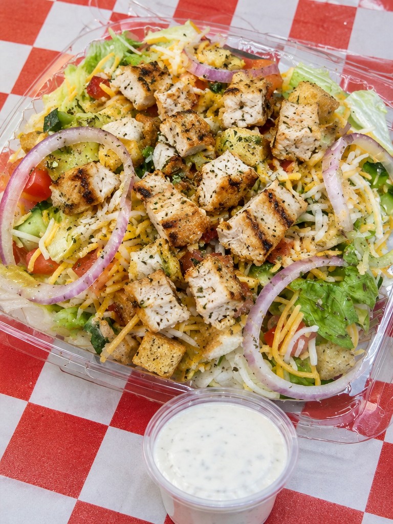 Grilled chicken salad with cheese, tomato, onion and dressing